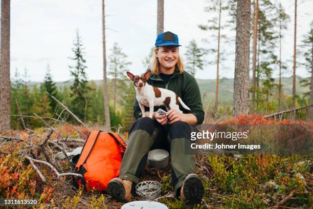 smiling man with dog - johner images bildbanksfoton och bilder