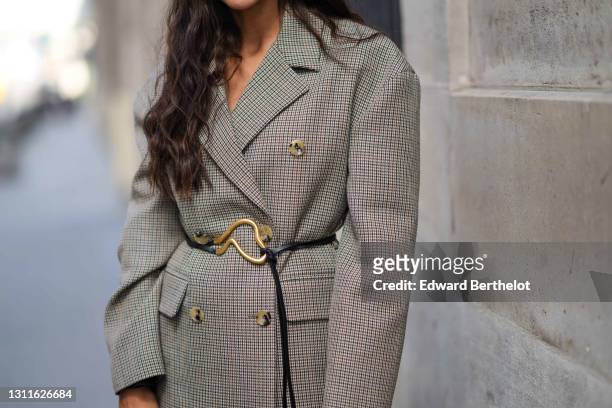 Tamara Kalinic wears an oversized blazer double breasted jacket with printed houndstooth patterns from Magda Butrym, a golden large belt from Bottega...