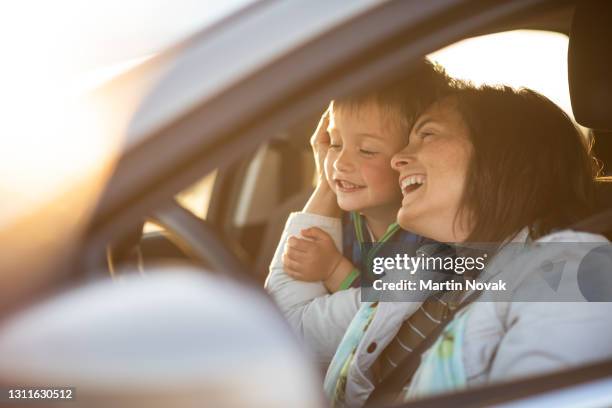 son hugging mother driving car - my son the driver stock pictures, royalty-free photos & images