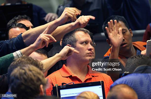 Traders signal offers in the Standard & Poor's 500 stock index options pit at the Chicago Board Options Exchange on November 2, 2011 in Chicago,...