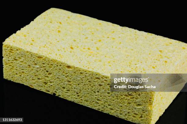 cleaning sponge on a black background - bath sponge stock pictures, royalty-free photos & images