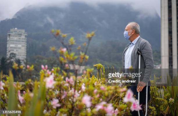 disabled senior man outdoors wearing a facemask during the pandemic - diabetic amputation stock pictures, royalty-free photos & images