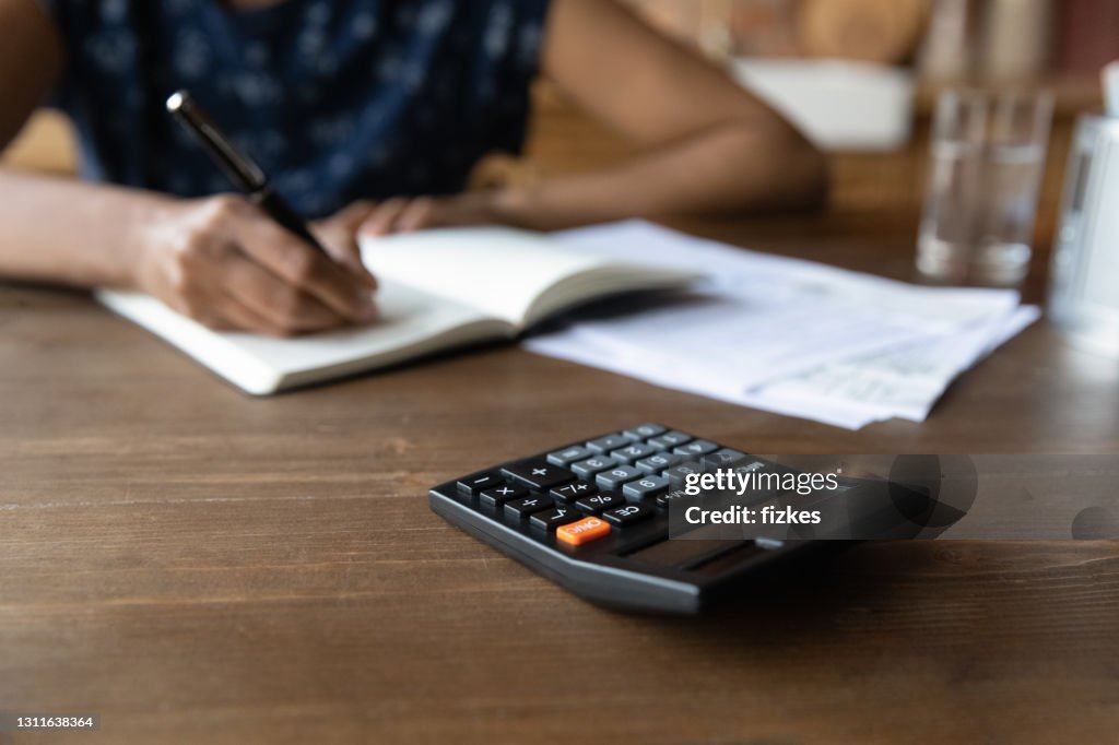 Cropped view of millennial black female work with financial papers