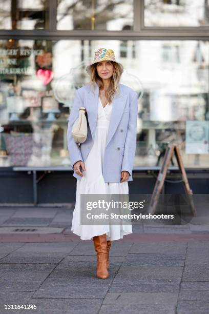 Fashion designer Sue Giers wearing brown knee high boots by Celine, a long white longsleeve dress by SoSUE, a lavender color blazer by Acne, a...