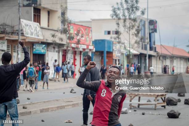 An activist satisfied with the action, sings in the middle of the street on April 9, 2021 in Goma, Democratic Republic of Congo. Shedding light on...
