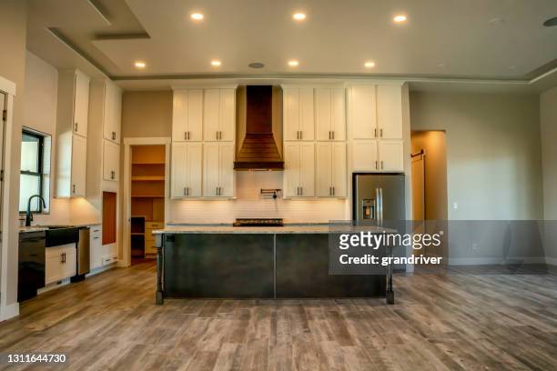 the kitchen interior of a newly constructed single family open concept home - kitchen wide stock pictures, royalty-free photos & images