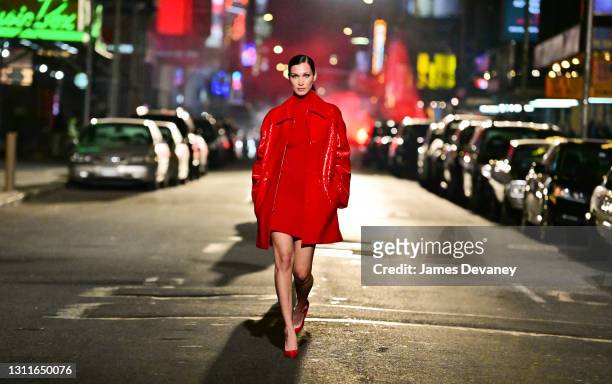 Bella Hadid walks along 46th Street during the Michael Kors Fashion Show in Times Square on April 08, 2021 in New York City.