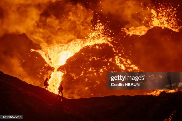 tourist hiking to observe active volcano in iceland - smoking crack stock pictures, royalty-free photos & images