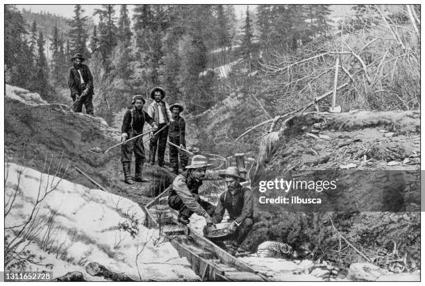 antique black and white photograph: klondike gold rush - gold panning stock illustrations