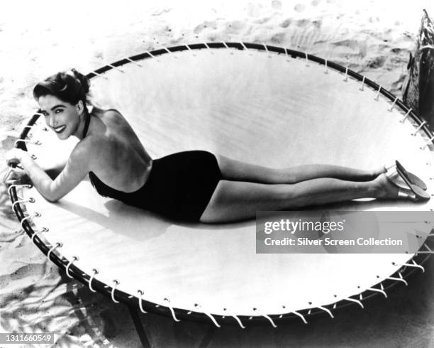 Actress Julie Adams as 'Kay' lays on a trampoline in film 'Creature from the Black Lagoon', 1954.