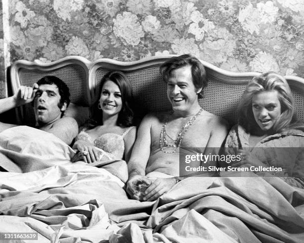 Actors Elliott Gould, Natalie Wood, Robert Culp, and Dyan Cannon in bed together in film 'Bob & Carol & Ted & Alice', 1969.