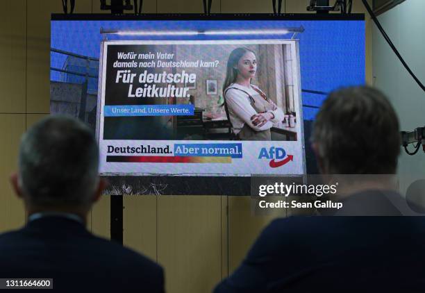 An election campaign film of the right-wing Alternative for Germany political party plays on a monitor at a press conference on the eve of the AfD...