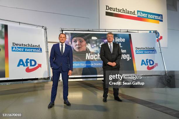 Tino Chrupalla and Joerg Meuthen, co-heads of the right-wing Alternative for Germany political party, pose for photographs next to AfD election...