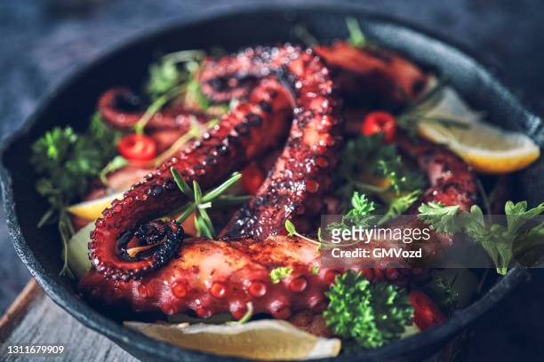 oktopus tentakel mit meersalz und frischer zitrone - calamares stock-fotos und bilder