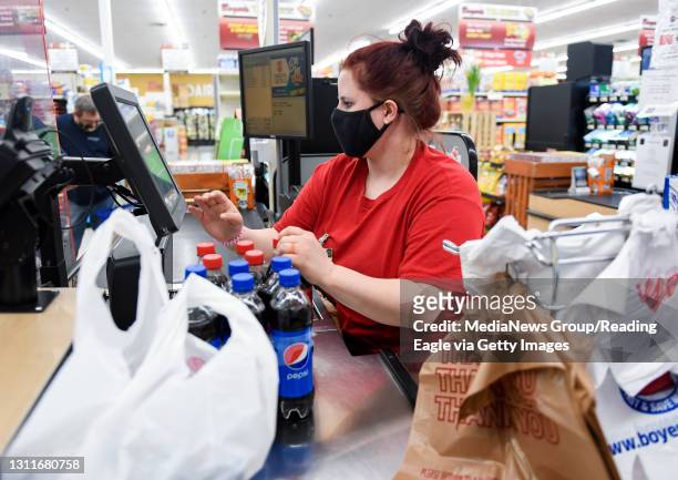Womelsdorf, PA Boyer's cashier Kathryn Laudermilch scans a customers groceries. At the Boyer's Food Markets grocery store in Womelsdorf Thursday...
