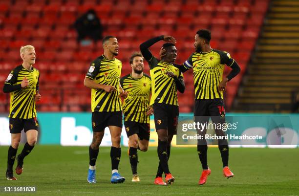 Ismaila Sarr of Watford FC celebrates with teammates William Troost-Ekong and Nathaniel Chalobah after scoring their team's first goal during the Sky...