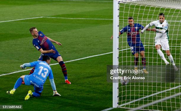 Denis Vavro of SD Huesca scores an own goal to make it the first goal for Elche during the La Liga Santander match between SD Huesca and Elche CF at...