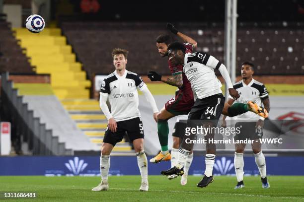 Willian Jose of Wolverhampton Wanderers scores their team's first goal under pressure from Ola Aina of Fulham which is later disallowed by VAR during...