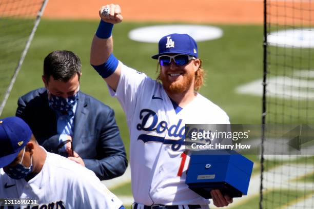 Justin Turner of the Los Angeles Dodgers acknowledges the crowd after receiving his World Series ring prior to the game against the Washington...