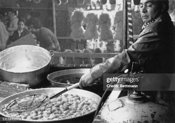 Man prepares food during the Feast of San Gennaro, Mulberry Street in the Little Italy district of the borough of Manhattan in New York City, New...