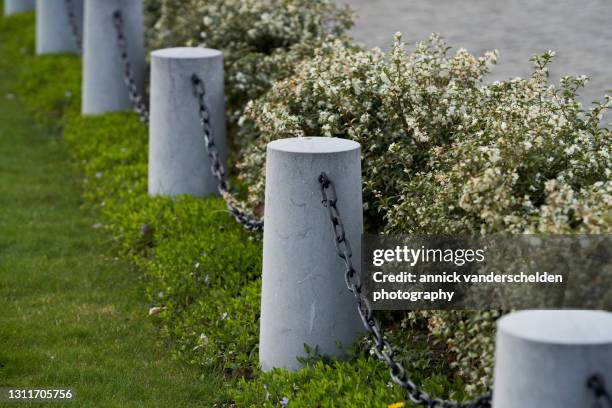 bollards and chain in garden - bollards stock pictures, royalty-free photos & images