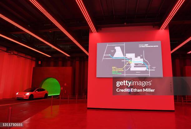 Tesla car drives through the Central Station near a digital map during a media preview of the Las Vegas Convention Center Loop on April 9, 2021 in...