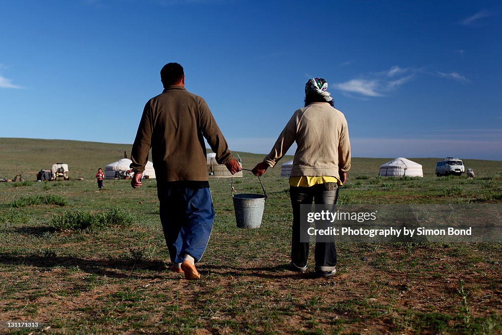 Couple holding bucket