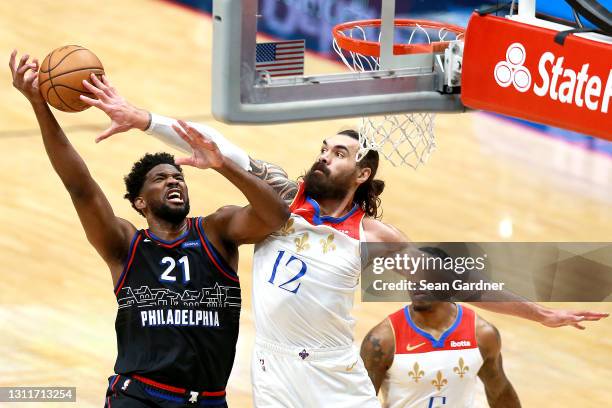 Joel Embiid of the Philadelphia 76ers is fouled by Steven Adams of the New Orleans Pelicans during the first quarter of an NBA game at Smoothie King...