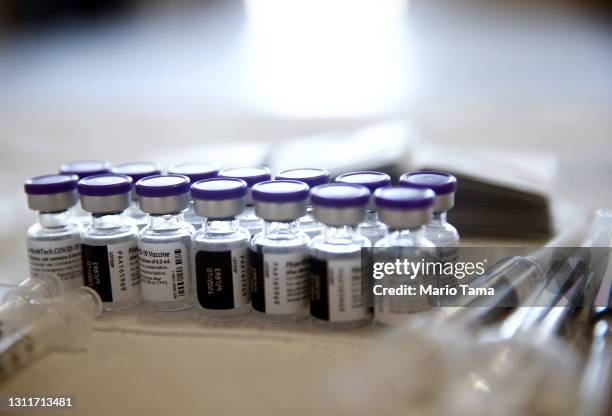 Vials containing doses of the Pfizer COVID-19 vaccine are viewed at a clinic targeting minority community members at St. Patrick's Catholic Church on...