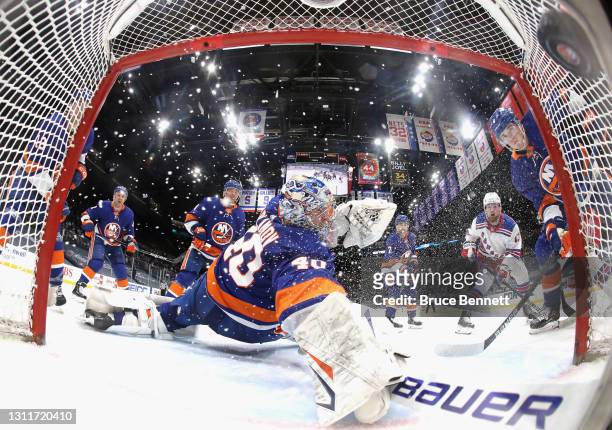 Alexis Lafreniere of the New York Rangers scores a second period goal against Semyon Varlamov of the New York Islanders at Nassau Coliseum on April...