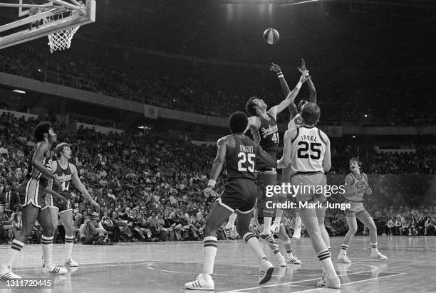 Indiana Pacers center Dave Robisch attempts to block a jump shot by Denver Nuggets center Marvin Webster during an ABA basketball game at McNichols...