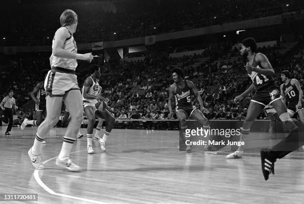 Indiana Pacers forward Travis Grant checks Denver Nuggets guard Ralph Simpson during an ABA basketball game against the Denver Nuggets at McNichols...