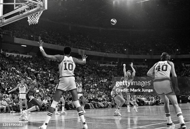 Indiana Pacers guard Bill Keller takes a three-point shot over Denver Nuggets guard Claude Terry during an ABA basketball game at McNichols Arena on...
