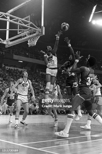 Denver Nuggets center Marvin “The Human Eraser” Webster attempts to block a shot by Indiana Pacers forward Charles Jordan during an ABA basketball...