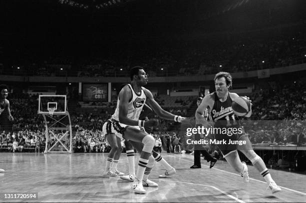 Indiana Pacer guard Bill Keller attempts to drive past Denver Nugget center Marvin Webster during an ABA basketball game at McNichols Arena on March...