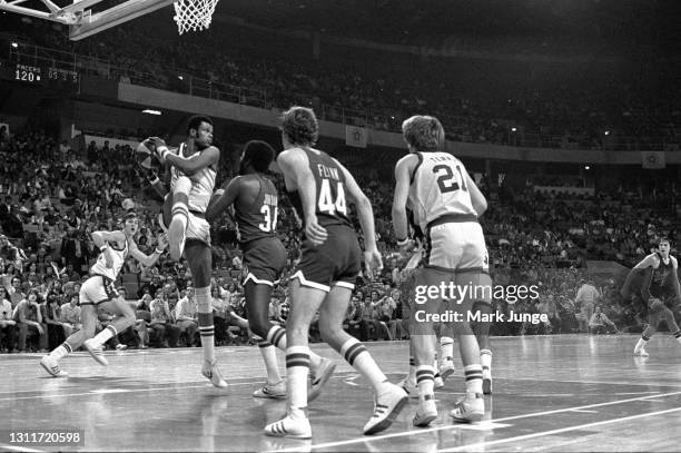 Denver Nuggets center Marvin Webster pulls a rebound away from Indiana Pacers forward Charles Jordan during an ABA basketball game at McNichols Arena...