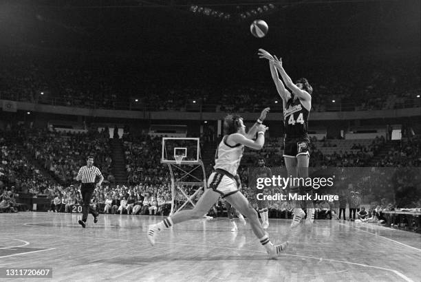 Indiana Pacers guard Mike Flynn takes a three-point shot over Denver Nuggets guard Claude Terry during an ABA basketball game at McNichols Arena on...