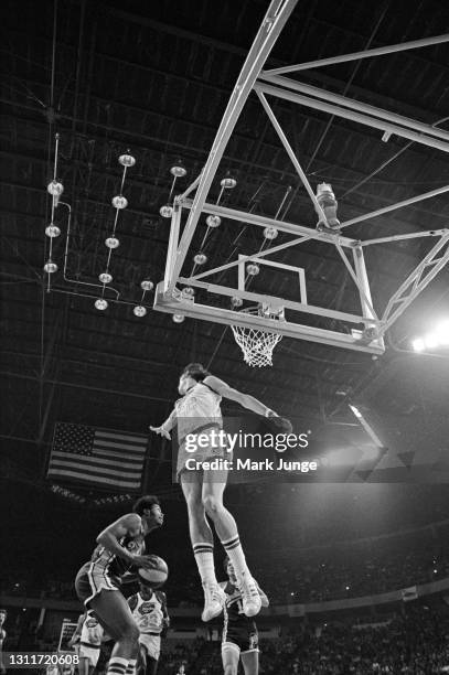 Denver Nuggets forward Gus Gerard leaps to block a layup by Indiana Pacers center Len Elmore during an ABA basketball game at McNichols Arena on...