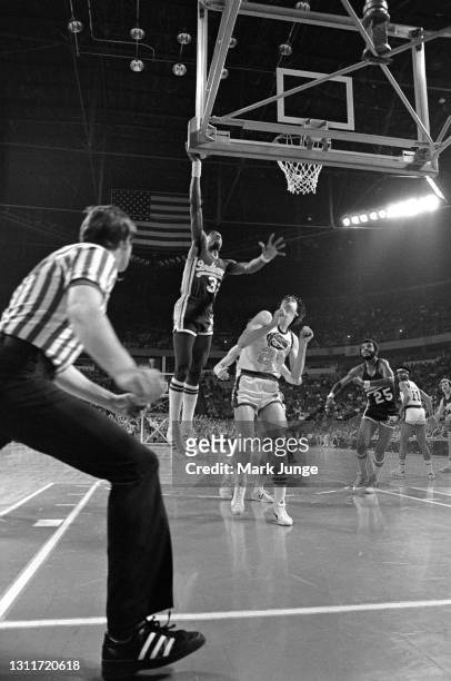 Indiana Pacers forward Dan Roundfield drives for a layup against Denver Nuggets forward Bobby Jones during an ABA basketball game against the Denver...