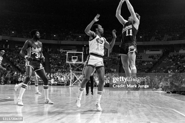Indiana Pacers guard Bill Keller takes a jump shot against Denver Nuggets guard Jimmy Foster during an ABA basketball game at McNichols Arena on...