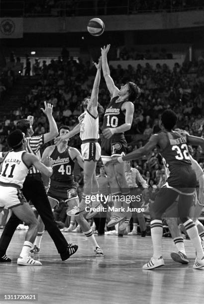 Indiana Pacers guard Don Buse and Denver Nuggets guard Monte Towe jump for a tipoff during an ABA basketball game at McNichols Arena on March 26,...