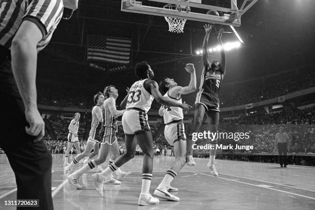 Indiana Pacers forward Travis Grant shoots a short jump shot over Denver Nuggets forward Bobby Jones during an ABA basketball game at McNichols Arena...