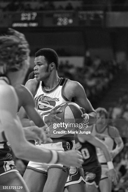 Denver Nuggets center Marvin Webster holds the ball while guarded by Indiana Pacers players during an ABA basketball game at McNichols Arena on March...