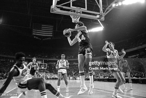 Indiana Pacers guard Mike Flynn pulls down a rebound during an ABA basketball game against the Denver Nuggets at McNichols Arena on March 26, 1976 in...