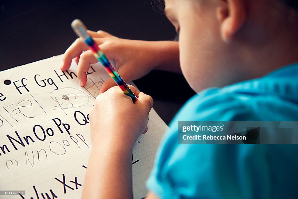 Preschool girl copying her letters