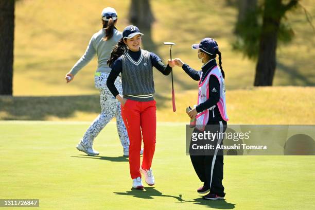 Amateur Haruka Kawasaki of Japan fist bumps with her caddie on the 6th green during the rest of the first round of the Fujiflim Studio Alice Ladies...