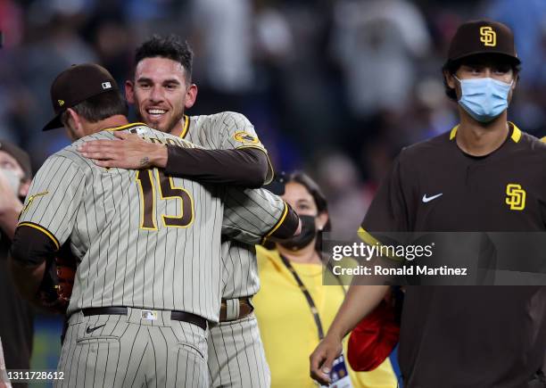 Joe Musgrove of the San Diego Padres celebrates with Drew Pomeranz after pitching a no-hitter against the Texas Rangers at Globe Life Field on April...