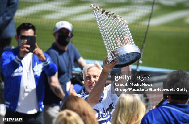 Los Angeles, CA Mark Walter, part-chairman of the Los Angeles Dodgers holds up the championship trophy during the World series ring ceremony prior to...