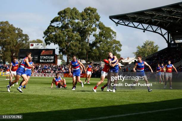 Adam Treloar of the Bulldogs handpasses the ball under pressure during the round four AFL match between the Western Bulldogs and the Brisbane Lions...