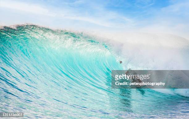 surfer in a clean barrel - surf tube stock pictures, royalty-free photos & images